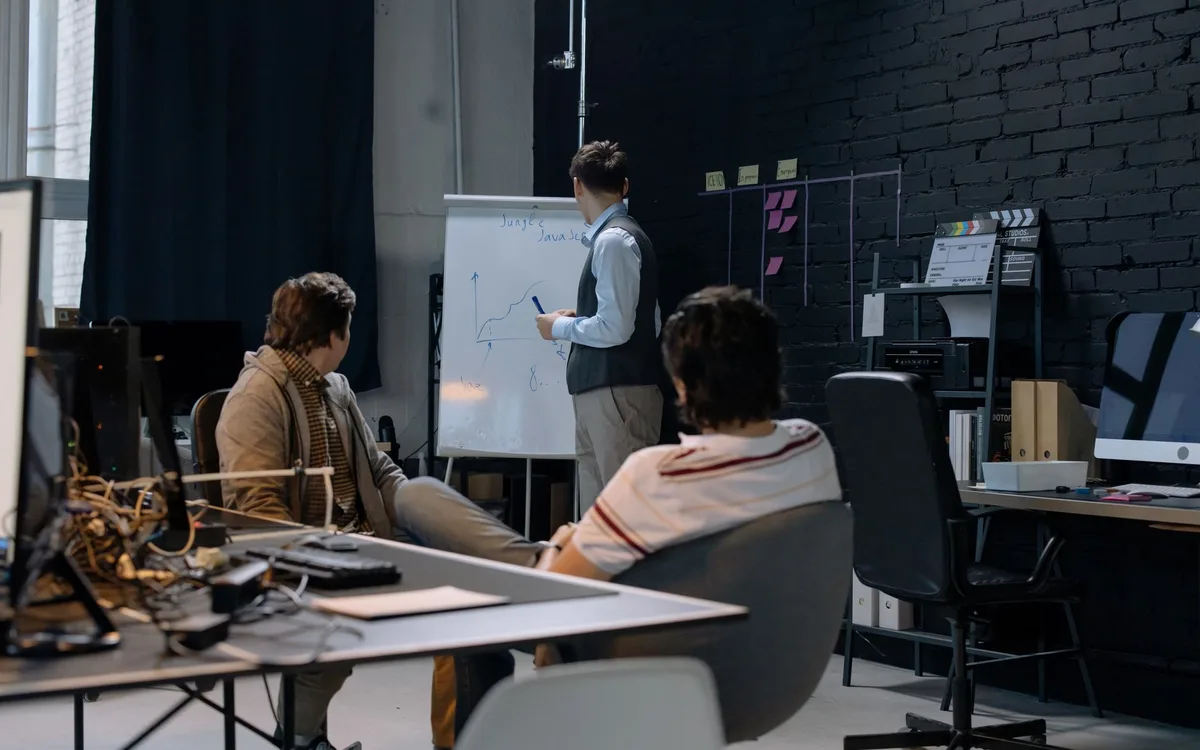 Small business team reviewing a whiteboard and assigning the next website and search visibility release