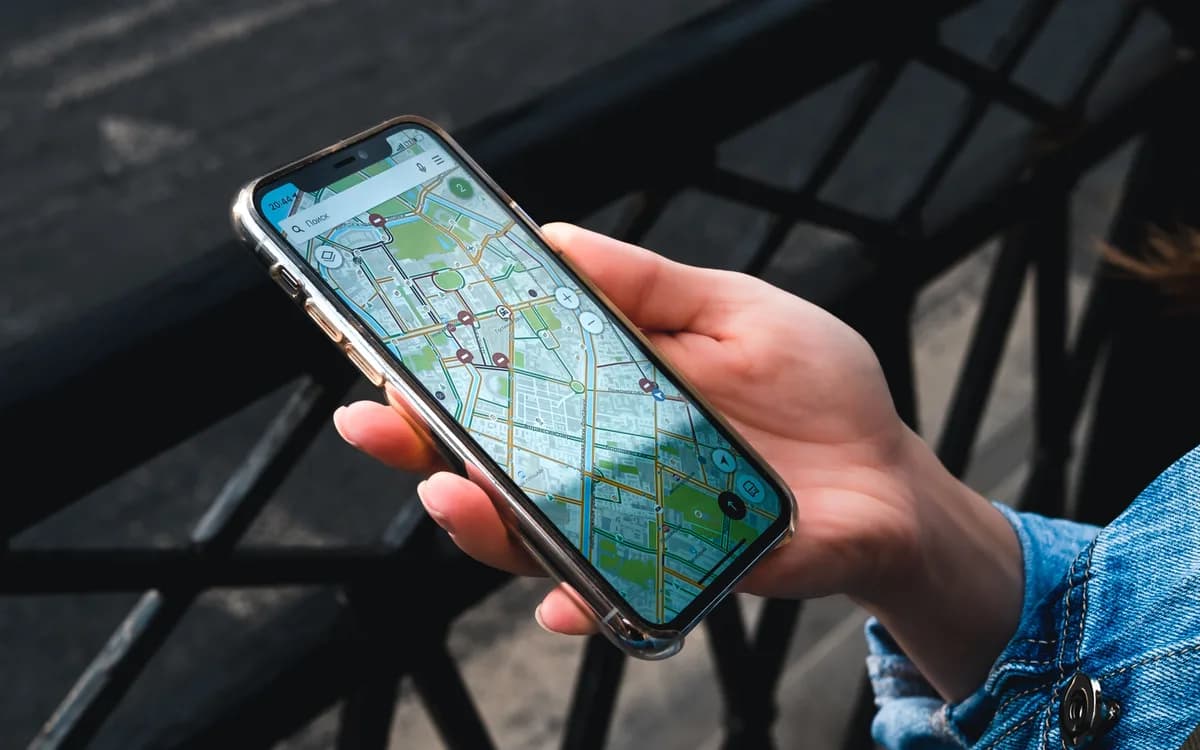 A person holding a smartphone with a city map open